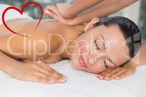 Composite image of content brunette enjoying a back massage