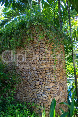 Ornate column in formal Balinese garden