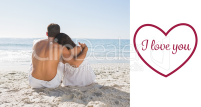 Composite image of couple sitting on the sand watching the sea