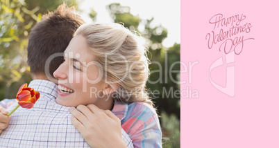 Composite image of smiling young couple embracing in park