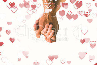 Composite image of happy senior couple holding hands