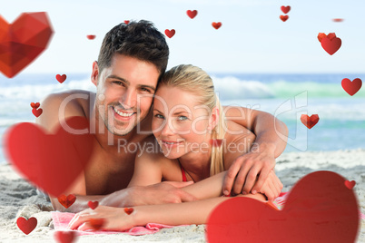 Composite image of lovers lying down on the beach