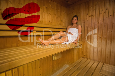 Composite image of calm brunette relaxing in a sauna