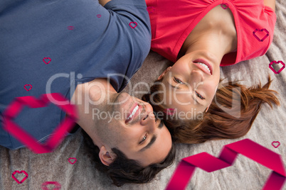 Composite image of two friends looking into the sky while lying