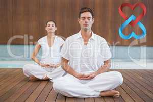 Composite image of peaceful couple in white sitting in lotus pos