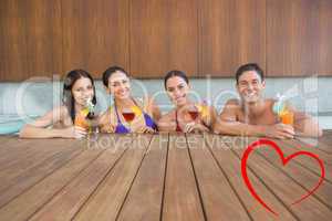 Composite image of cheerful people with drinks in swimming pool