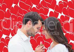 Composite image of handsome man offering his girlfriend a rose