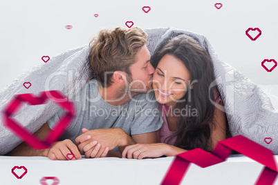 Composite image of attractive man kissing his wife