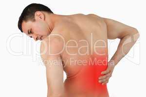Back view of male suffering from back pain