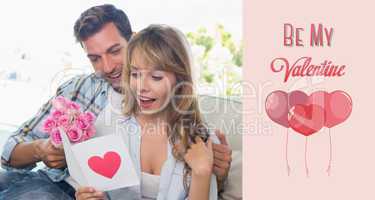 Composite image of loving couple with flowers and greeting card