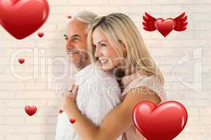 Composite image of affectionate couple standing and hugging