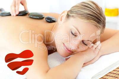 Composite image of relaxed woman having a massage