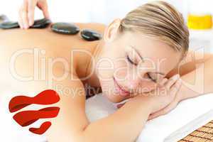 Composite image of relaxed woman having a massage