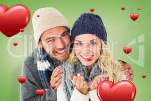 Composite image of attractive couple in winter fashion smiling a