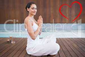 Composite image of content brunette in white sitting in lotus po