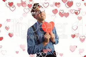 Composite image of geeky hipster covered in kisses