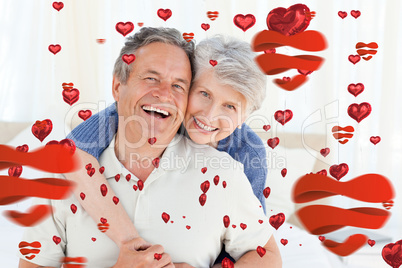 Composite image of senior couple looking at the camera
