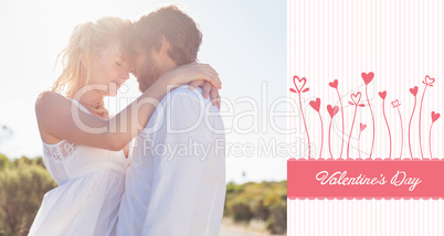 Composite image of attractive couple embracing by the road