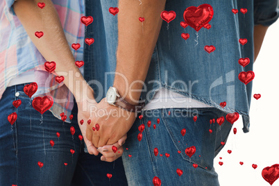 Composite image of hip young couple holding hands