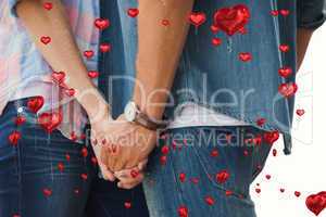 Composite image of hip young couple holding hands