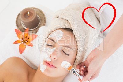Composite image of attractive woman receiving treatment at spa c