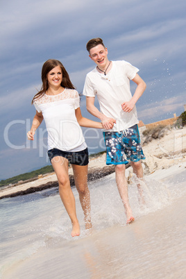 happy young couple on the beach in summer holiday love