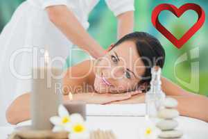 Composite image of beautiful brunette enjoying a back massage sm
