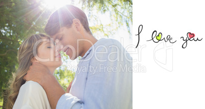 Composite image of cute couple hugging and smiling in the park