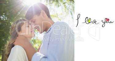 Composite image of cute couple hugging and smiling in the park