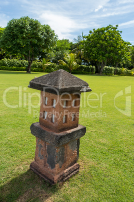 Ornate column in formal Balinese garden