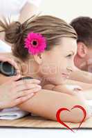 Composite image of cheerful young couple enjoying a spa treatmen