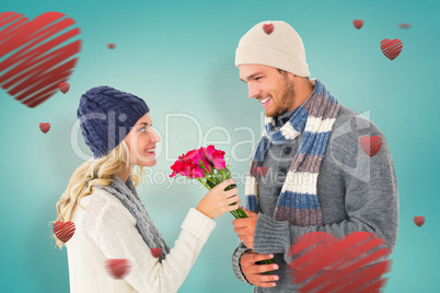 Composite image of attractive man in winter fashion offering ros