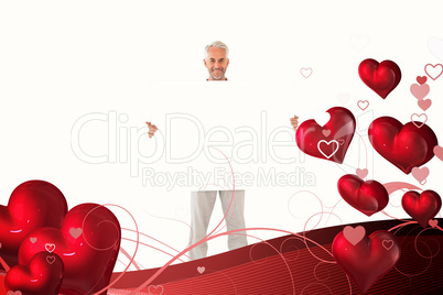 Composite image of smiling man showing large poster