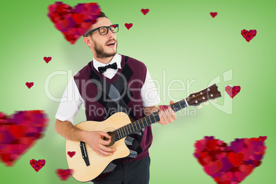 Composite image of geeky hipster playing guitar and singing