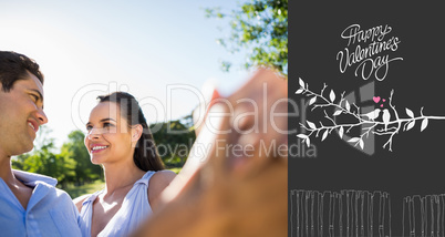 Composite image of loving and happy couple dancing at park