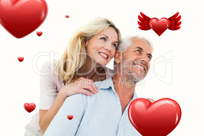 Composite image of smiling couple embracing and looking