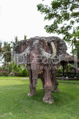 Elephant statue standing on a lawn at a park