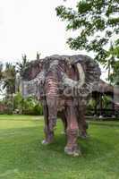 Elephant statue standing on a lawn at a park