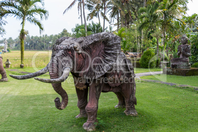 Elephant statue standing on a lawn at a park