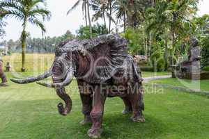 Elephant statue standing on a lawn at a park