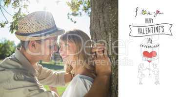 Composite image of cute smiling couple leaning against tree in t