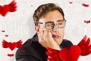 Composite image of young geeky businessman looking bored