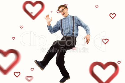 Composite image of geeky hipster walking and looking at camera