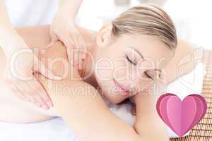 Composite image of beautiful woman receiving a back massage