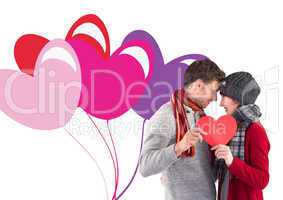 Composite image of couple holding a red heart