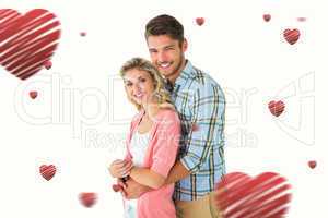 Composite image of attractive couple embracing and smiling at ca