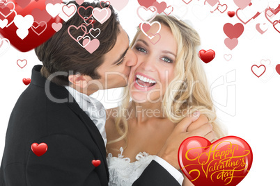 Composite image of handsome bridegroom kissing his wife on her c