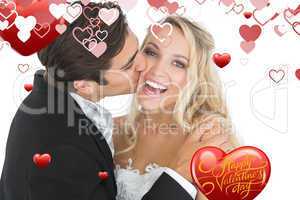Composite image of handsome bridegroom kissing his wife on her c