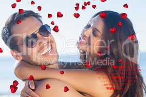 Composite image of cheerful loving couple hugging each other