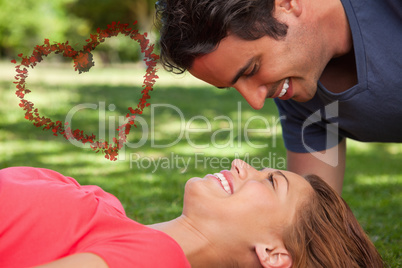 Composite image of man smiling as he looks down into his friends